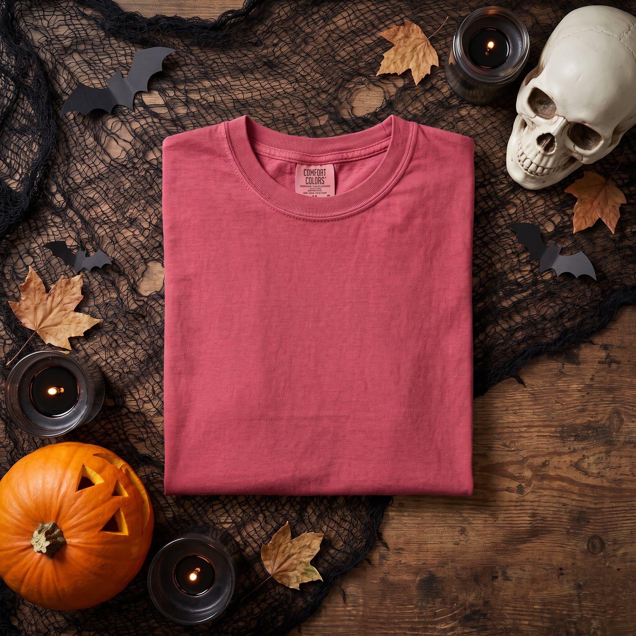 Comfort Colors 1717 t-shirt mockup in Crimson — Halloween-themed flat lay shot, chest panel left clean